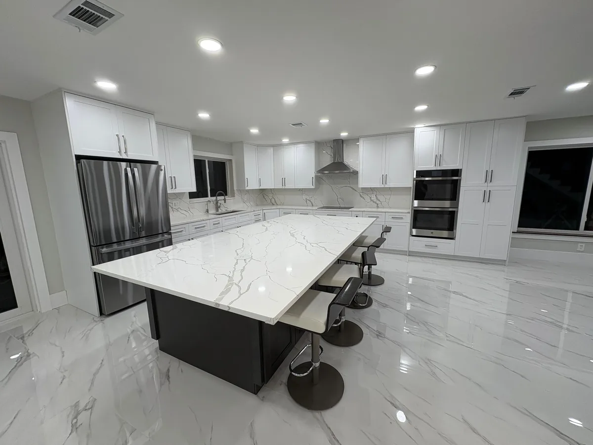 Renovated modern kitchen with quartz island — after